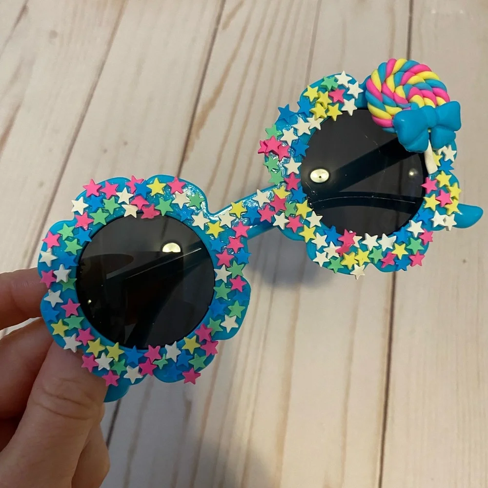 Girls electric blue flower shaped sunglasses